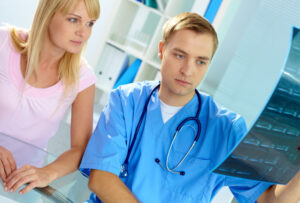 Doctor from TMJ Care Tucson explaining a treatment for tmj to a young lady