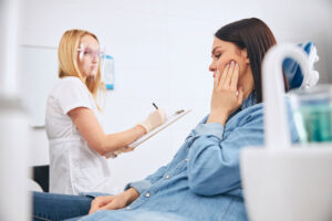 A TMJ specialist from TMJ Care Tucson assisting a patient